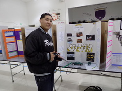 Male student presenting his project at the Science, Technology, Engineering, and Math fair.